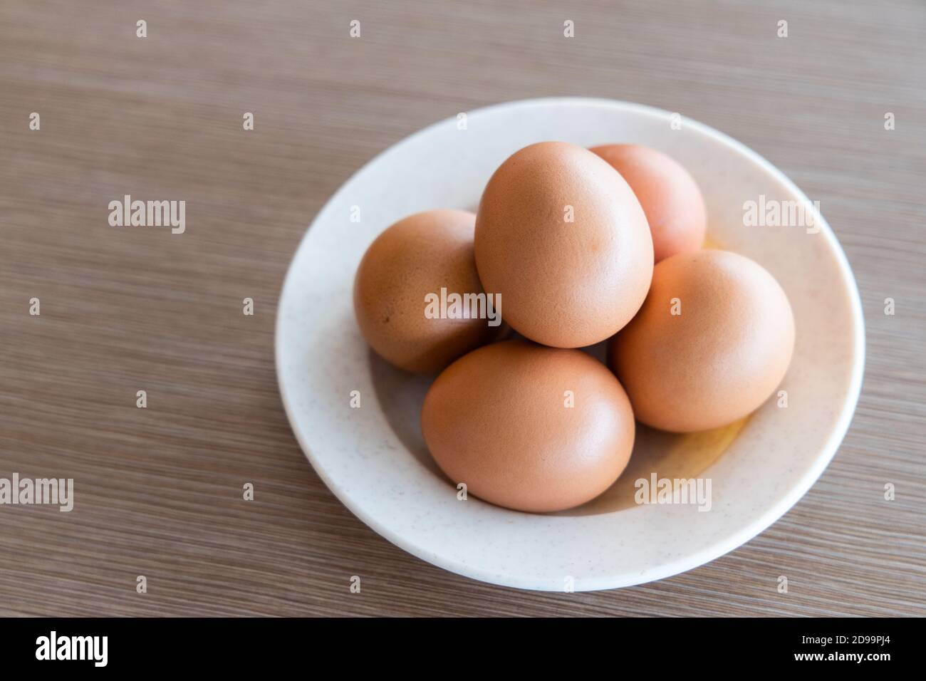 Farm fresh organic chicken eggs on plate with natural light Stock Photo