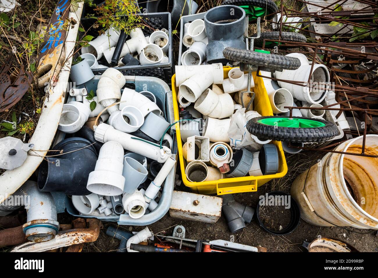 Plastic bins with plastic pipes, elbows, y's and t's at a recycling facility. Stock Photo