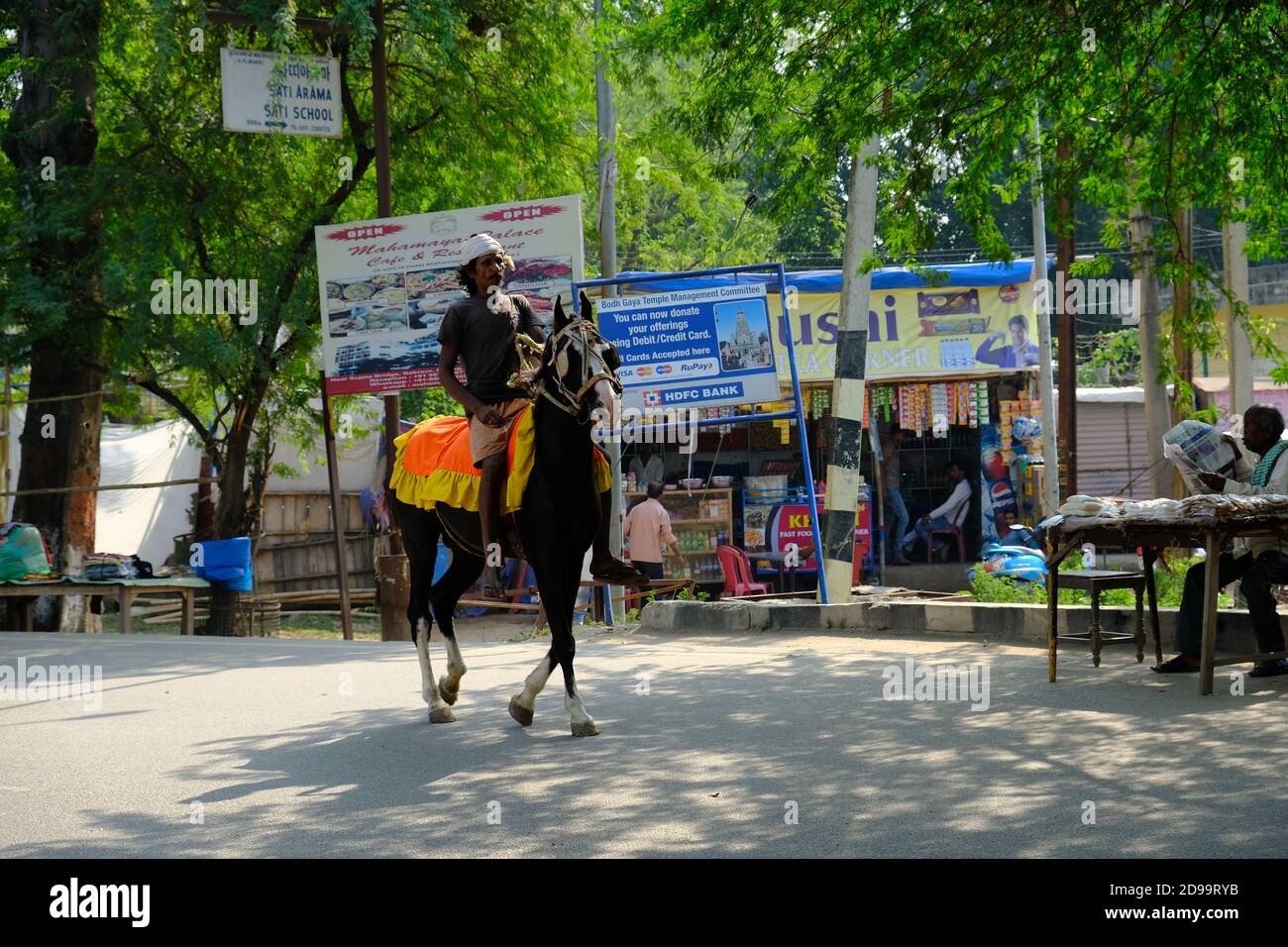 India Bodh Gaya - Horse and rider in city area Stock Photo