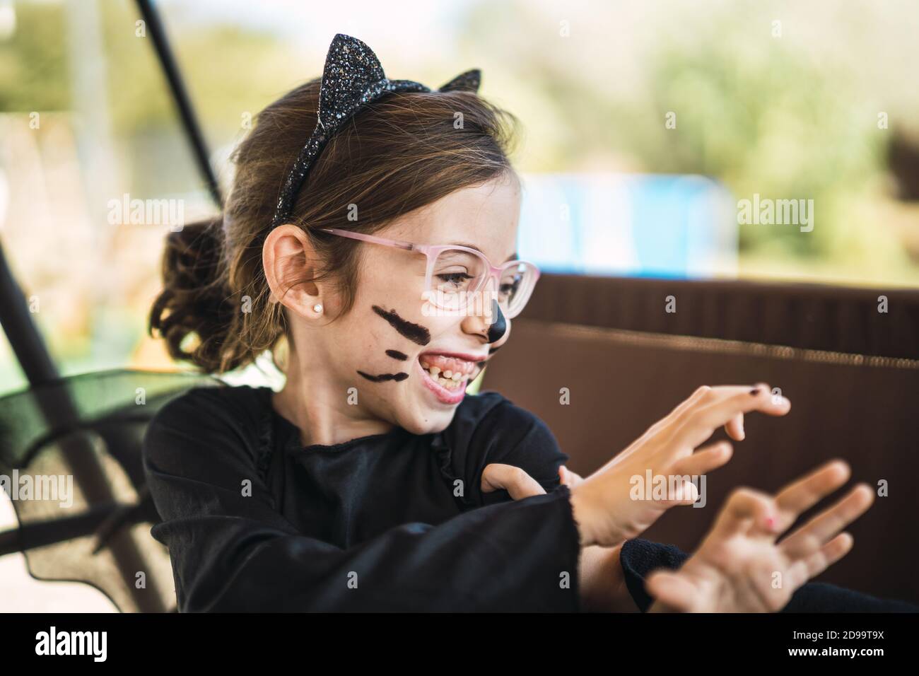 Cute little girl wearing a Halloween cat costume Stock Photo - Alamy