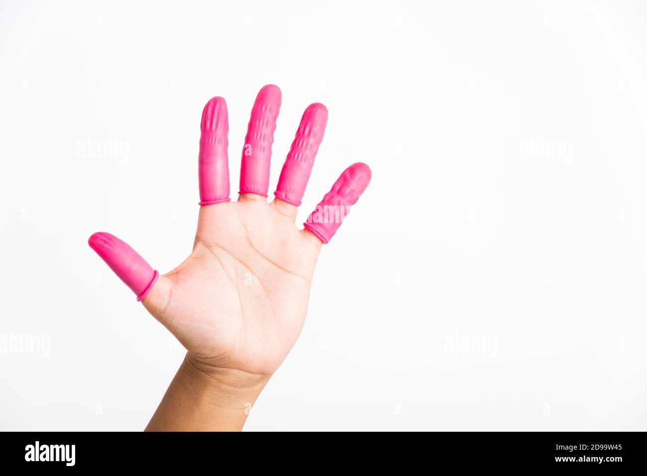 Woman hand wearing pink finger cots rubber protect help prevent