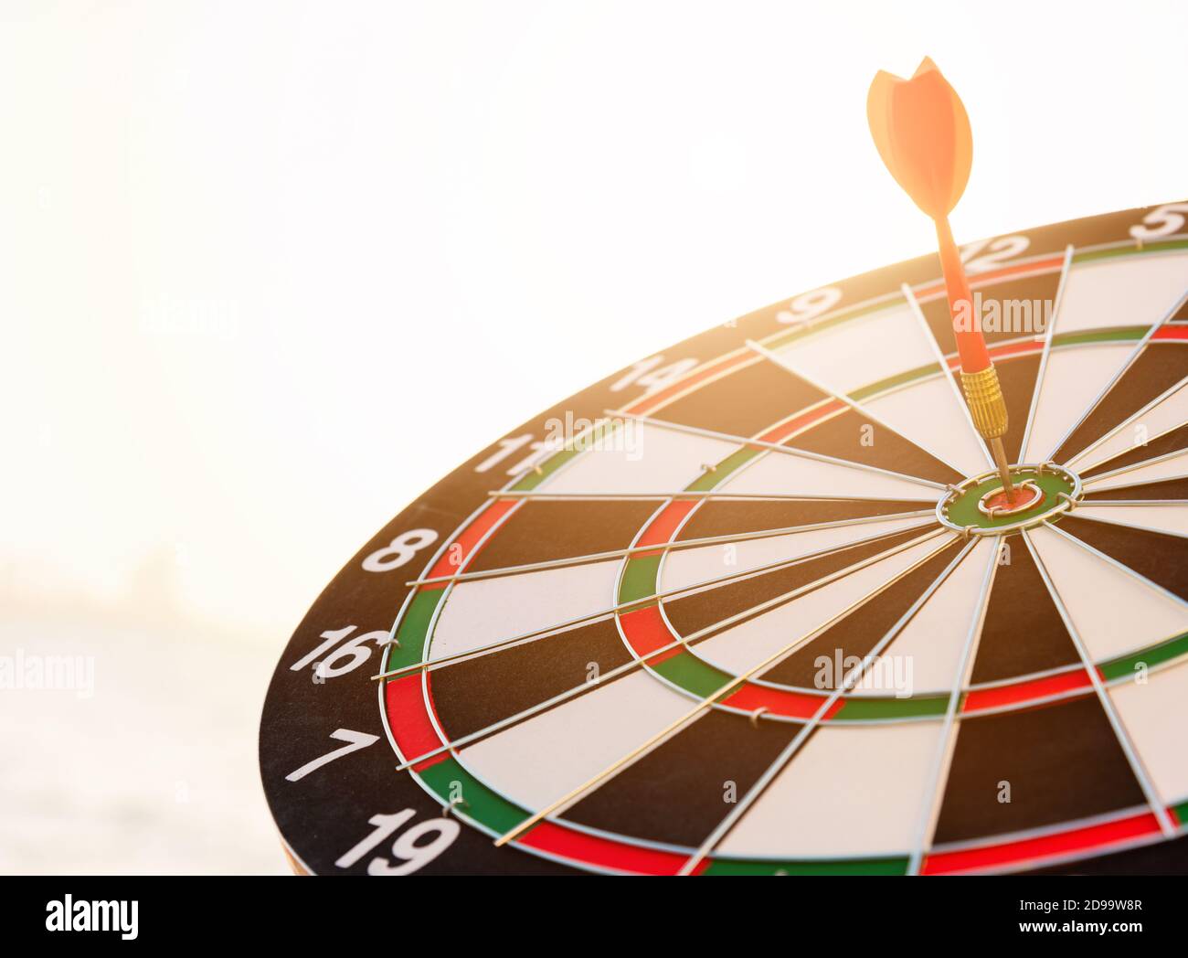 Dart arrow hitting to center on bullseye (bull'seye) dartboard is the