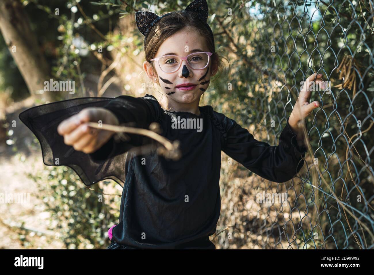 Cute little girl wearing a Halloween cat costume Stock Photo - Alamy