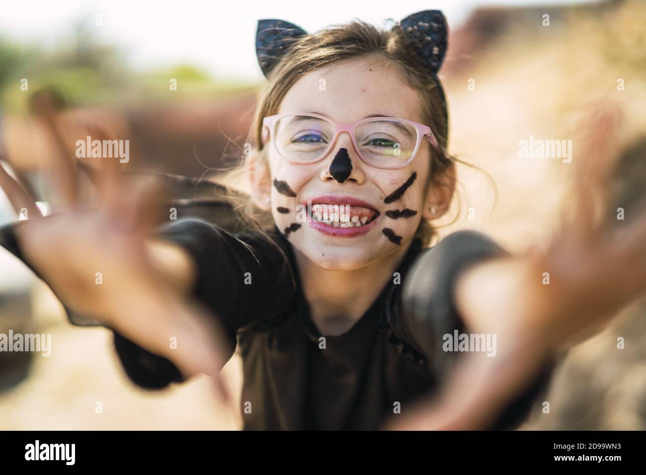 Cute little girl wearing a Halloween cat costume Stock Photo - Alamy