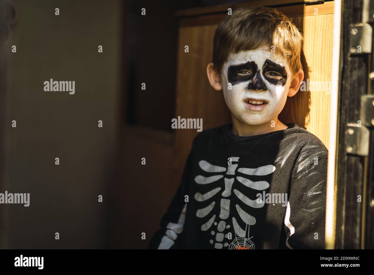 Cute little boy wearing a Halloween skeleton costume complaining about something Stock Photo Alamy