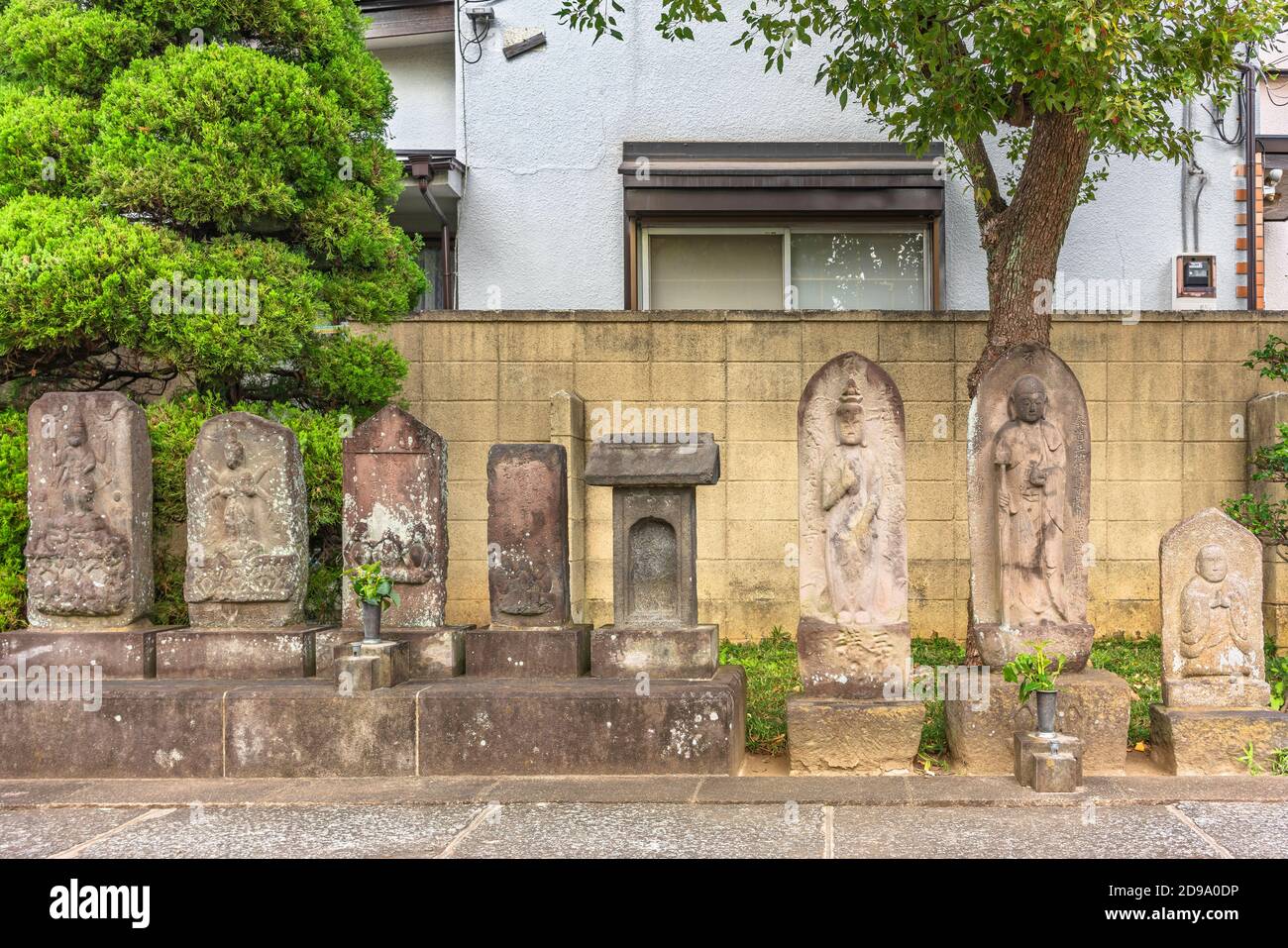 tokyo, japan - november 01 2020: Kōshintō carved stones depicting the Buddhist blue-faced king of light, the three wise monkeys, shaka nyorai, kosodat Stock Photo