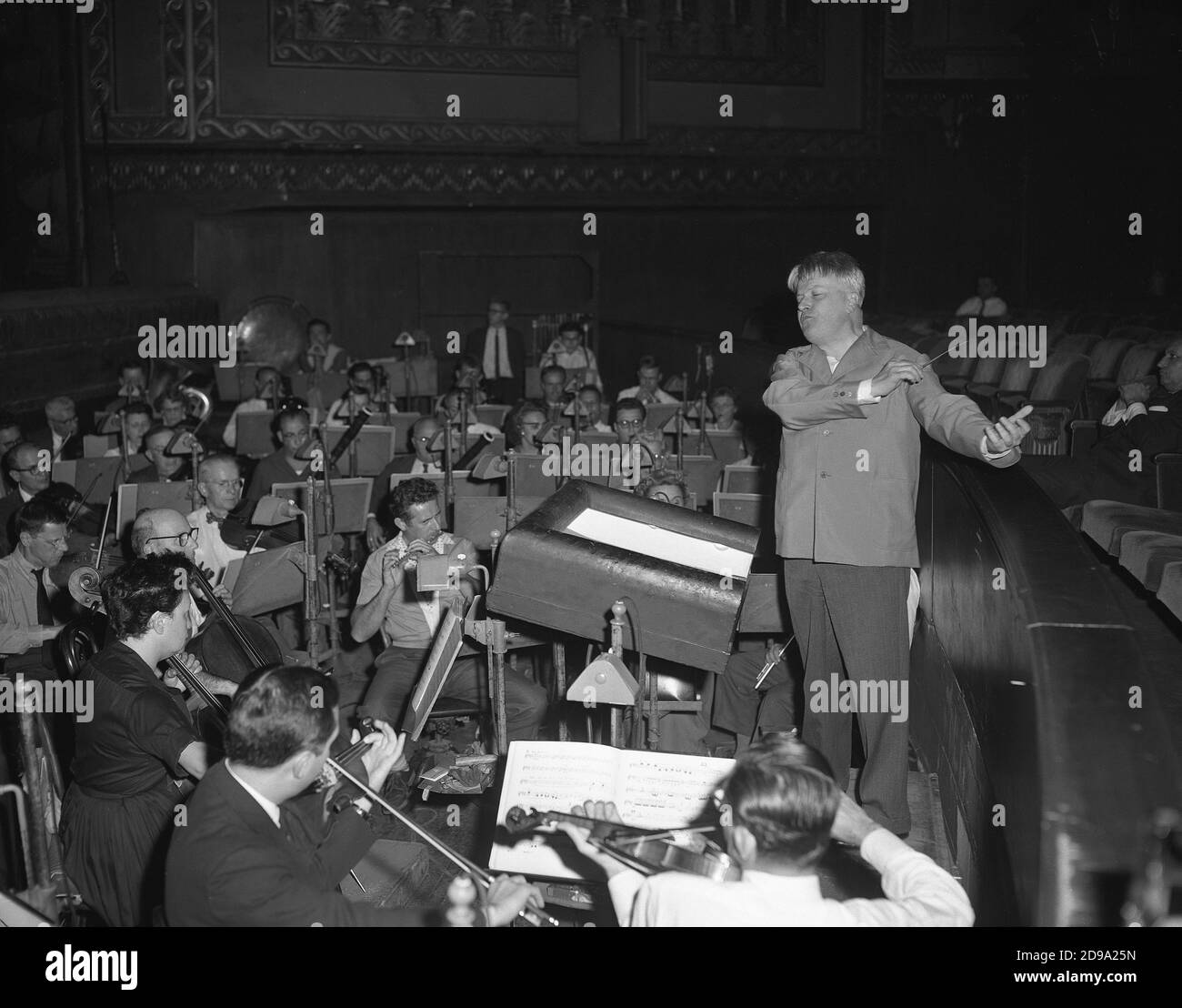 1959 , CHICAGO , USA : The renowned italian music conductor GIANANDREA GAVAZZENI ( 1909 - 1996 ) and the orchestra rehearsing Giuseppe Verdi 's ' Simon Boccanegra '  in Chicago's Opera House, October 22, 1959 . Gianandrea Gavazzeni (25 July 1909 - 5 February 1996) was an Italian pianist, conductor (especially of opera), composer and musicologist . Gavazzeni was born in Bergamo. For almost 50 years, starting from 1948, he was principal conductor at La Scala, Milan, in 1966-68 being its music and artistic director. He had his Metropolitan Opera debut on 11 October 1976 . He conducted eight perfo Stock Photo