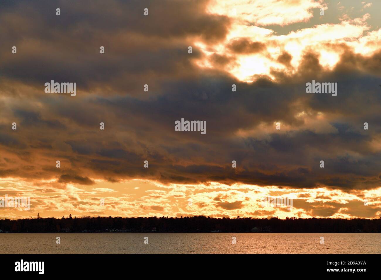 Trout Lake, Michigan, USA. Clearing clouds allow the late afternoon sun