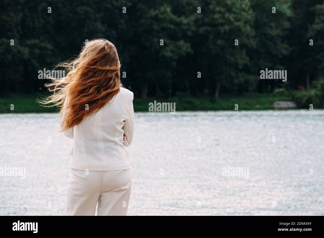 woman standing backwards and watching magic landscape. Stock Photo