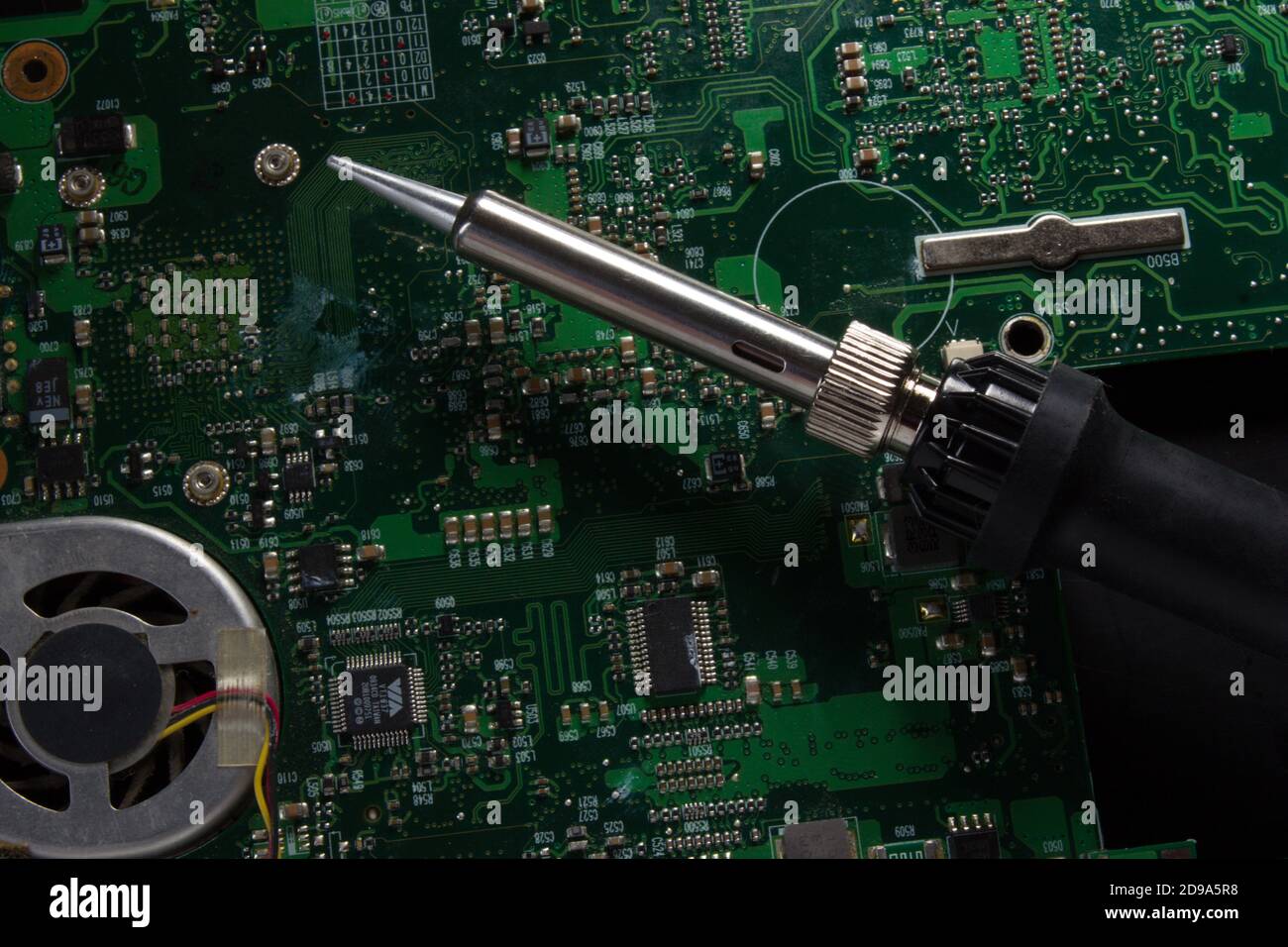use a soldering iron to solder the electronic part to the Board. Computer  repair. Macrophotography Stock Photo - Alamy