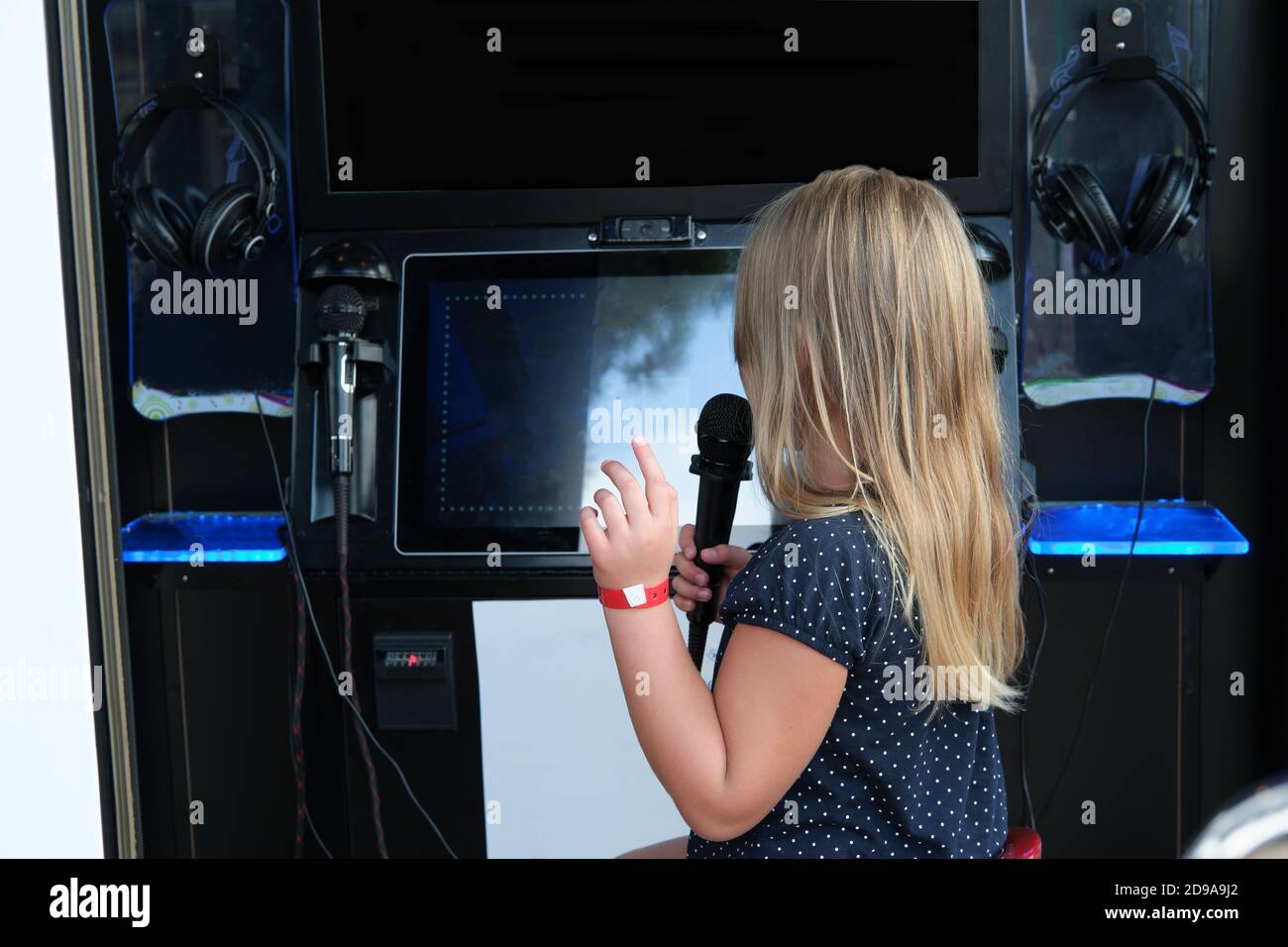 little girl singing in individual Karaoke room in shopping mall