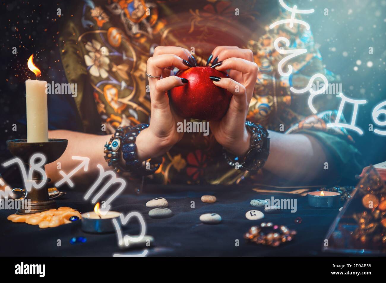 Astrology and divination. A fortune teller holds a red Apple in her