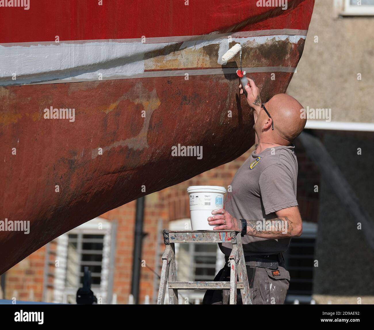 Boat out of the water at a seaside resort being cleaned and painted. Stock Photo