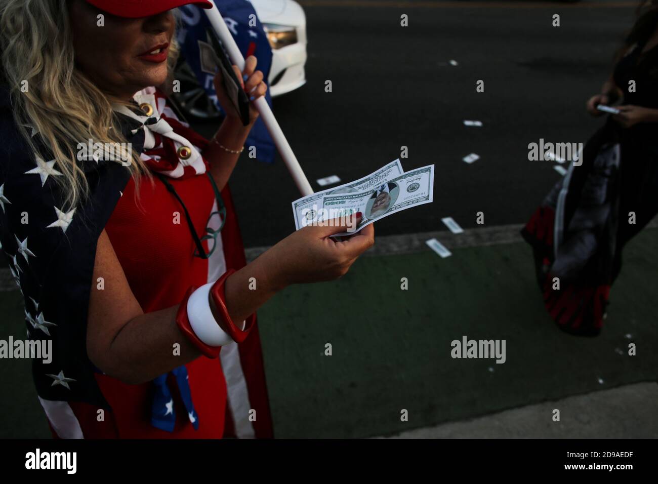 A Trump support holds fake dollar bills with a picture of President Trump on the bills during the Trump rally at Beverly Hills Garden Park.On the night of the United States Presidential Election on Tuesday, November 3, 2020, supporters of President Donald Trump met at Beverly Gardens Park in Beverly Hills, California to call for the reelection of Donald Trump. Stock Photo