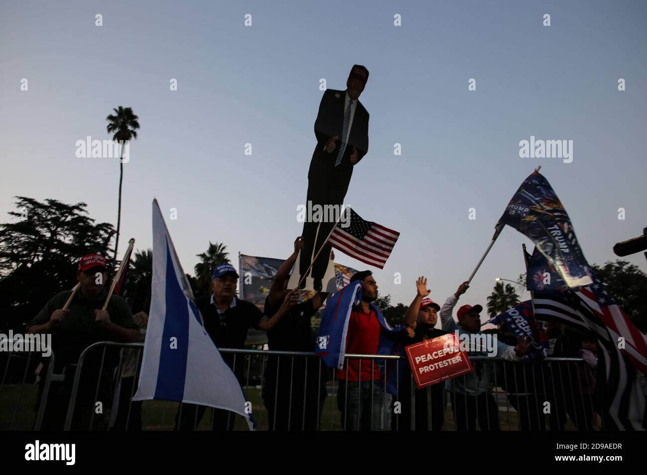 Supporters of President Trump hold placards and posters in support of President Trump during the Trump rally at Beverly Hills Garden Park.On the night of the United States Presidential Election on Tuesday, November 3, 2020, supporters of President Donald Trump met at Beverly Gardens Park in Beverly Hills, California to call for the reelection of Donald Trump. Stock Photo