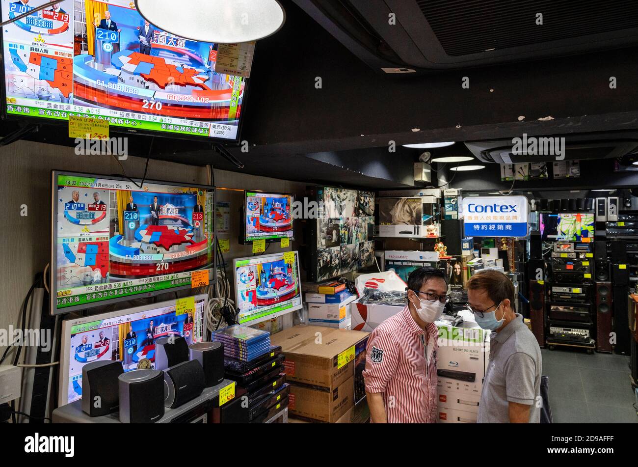 An electronic goods store shows live news of the US presidential election on its television screens in Hong Kong. Stock Photo