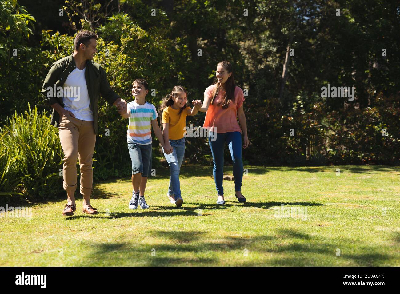 Caucasian family walking outside on a sunny day Stock Photo