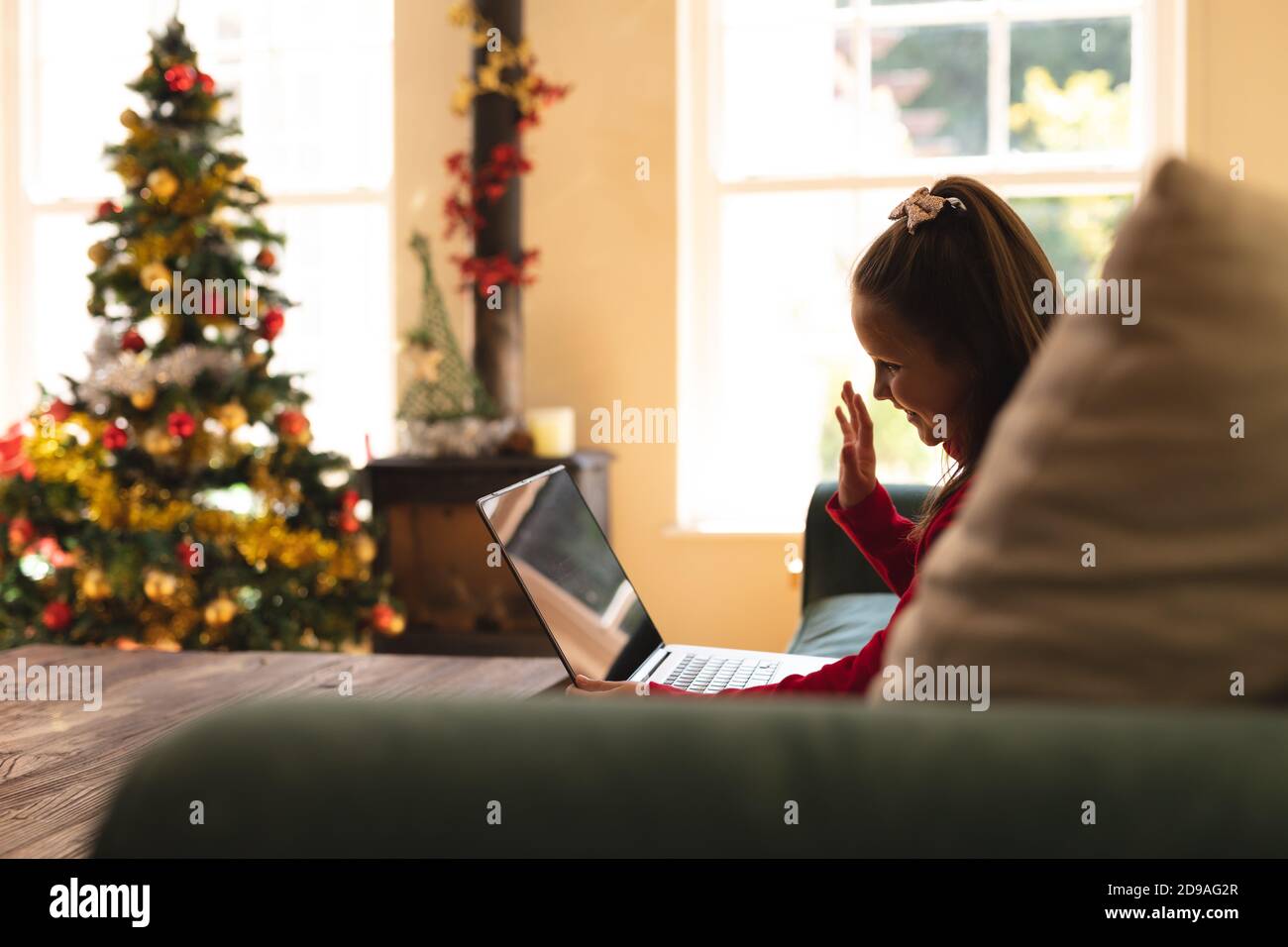 Caucasian girl sitting on couch Stock Photo Alamy