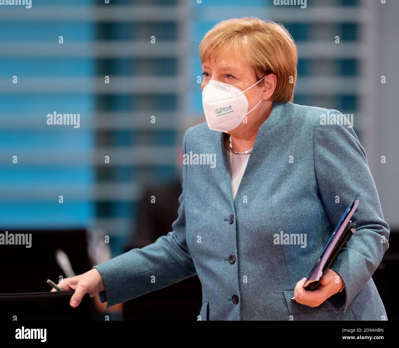 Berlin, Germany. 04th Nov, 2020. Chancellor Angela Merkel arrives at the meeting of the Federal Cabinet in the Federal Chancellery with a mouth-nose cover. Topics of the meeting are, among others, an amendment to the Federal Hunting Act and a bill for the mobilisation of building land. Credit: Kay Nietfeld/dpa pool/dpa/Alamy Live News Stock Photo