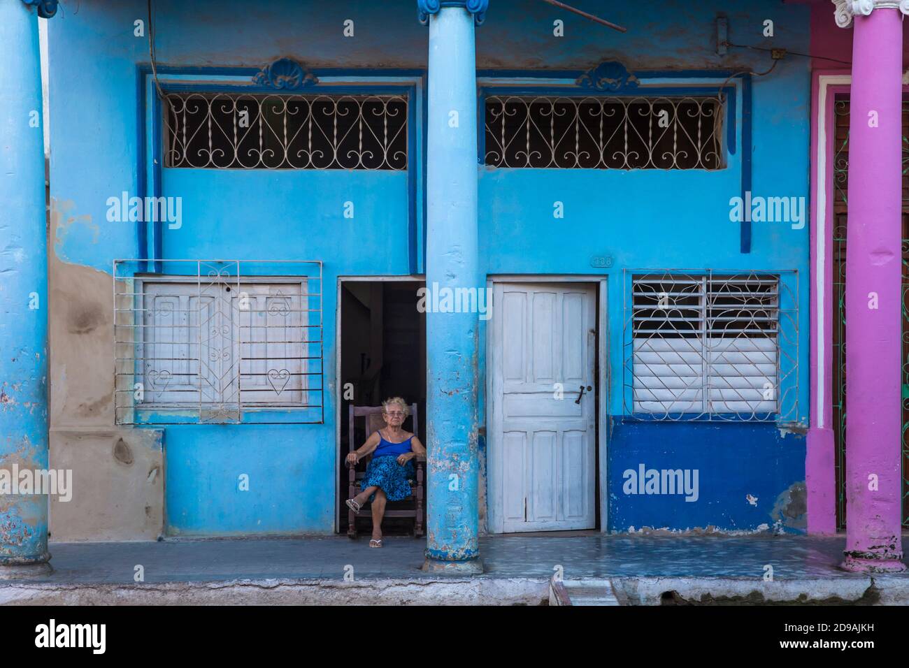 Cuba, Ciego de Ávila Province, Moron, Lady sitting in doorway of house Stock Photo