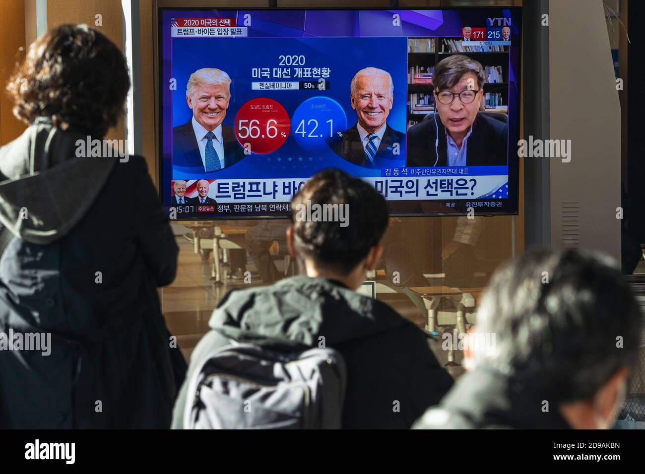 People at Seoul Train Station watch TV news report about the US Presidential election comparing Joe Biden with Donald Trump on 2020 US presidential election day. Stock Photo