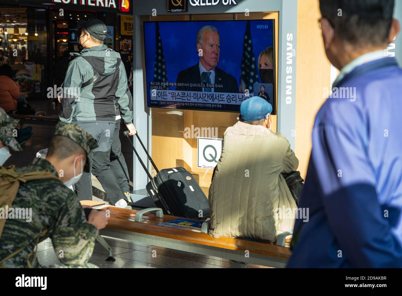 People at Seoul Train Station watch presidential candidate, Joe Biden on TV news report during the US Presidential election on 2020 US presidential election day. Stock Photo