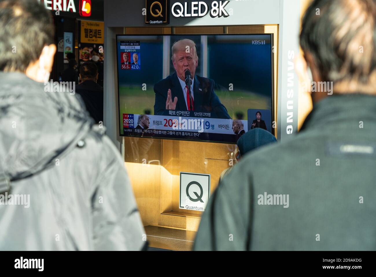 People at Seoul Train Station watch presidential candidate, Donald Trump on TV news report during the US Presidential election on 2020 US presidential election day. Stock Photo