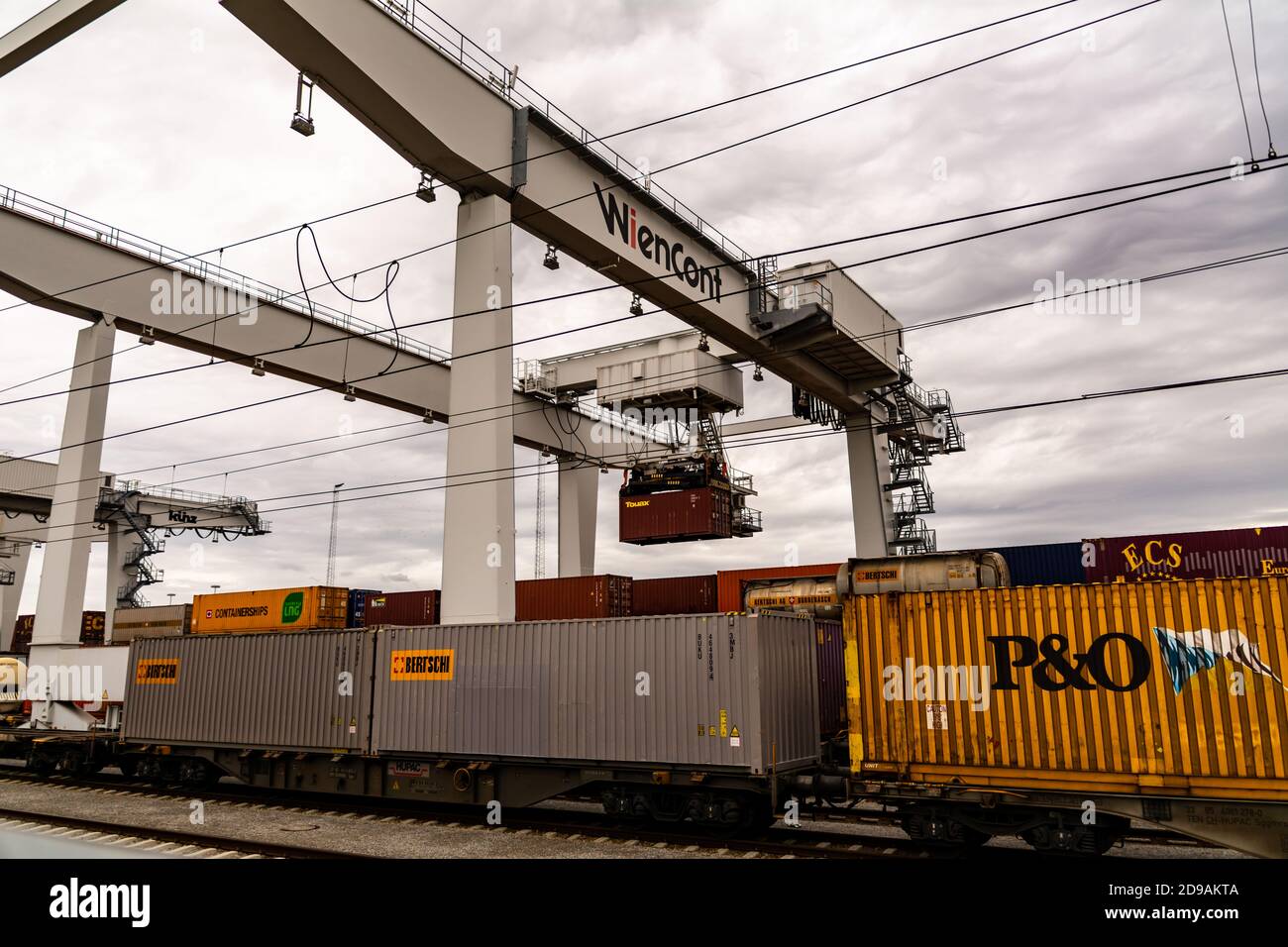 Crane loading and unloading shipping containers on a train in the ...