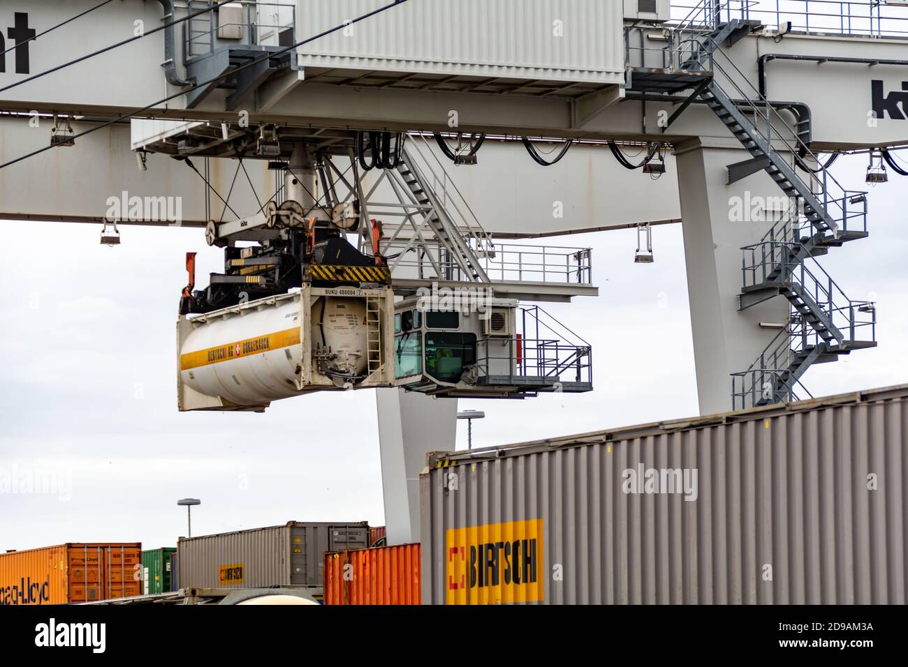 Crane loading and unloading shipping containers on a train in the ...