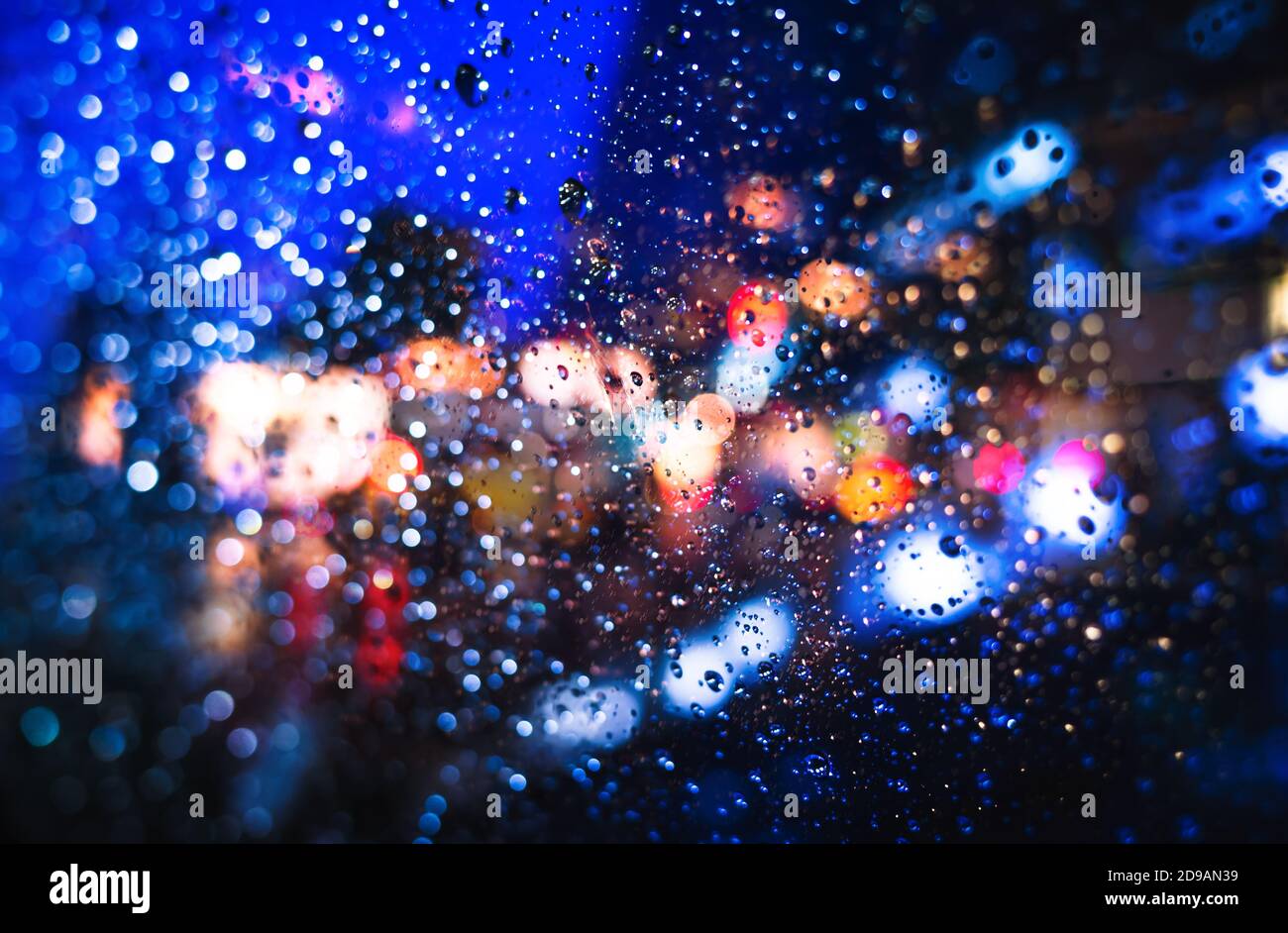 Blurred New York City street background with waterdrops, neon lights ...