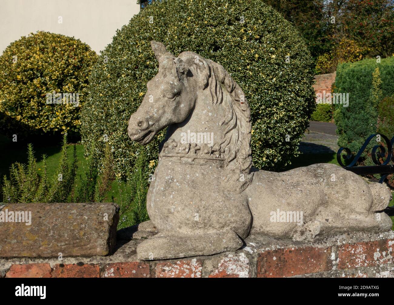 Large stone sculpture of a horse at the entrance to a driveway Stock