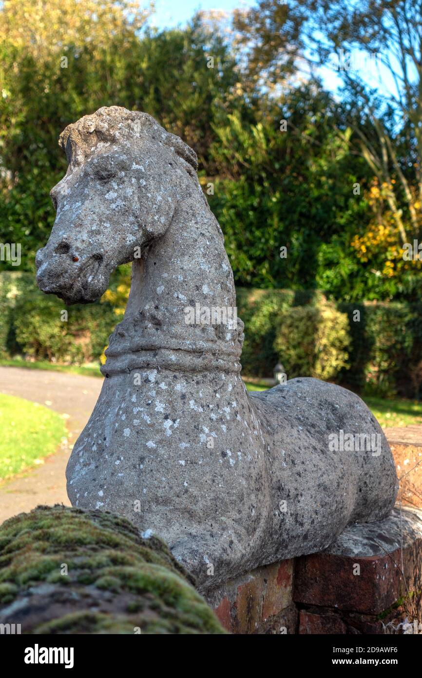 Large stone sculpture of a horse at the entrance to a driveway Stock