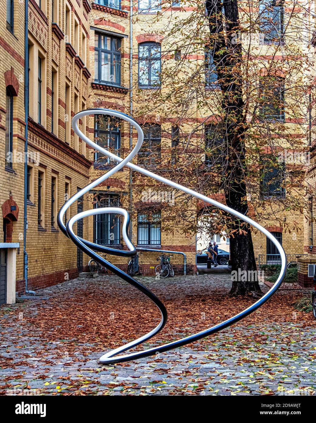 Modern steel sculpture in inner courtyard of refurbished historic brick Royal Loan Office building in Linienstraße, Mitte, Berlin Stock Photo