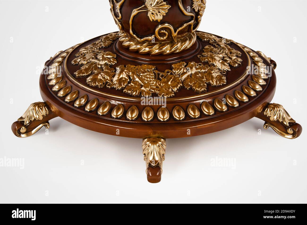 Luxury gold plated leg kitchen table in baroque style. Closeup Stock