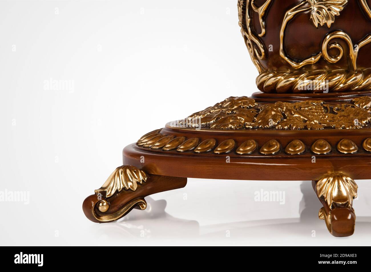 Luxury gold plated leg kitchen table in baroque style. Closeup Stock