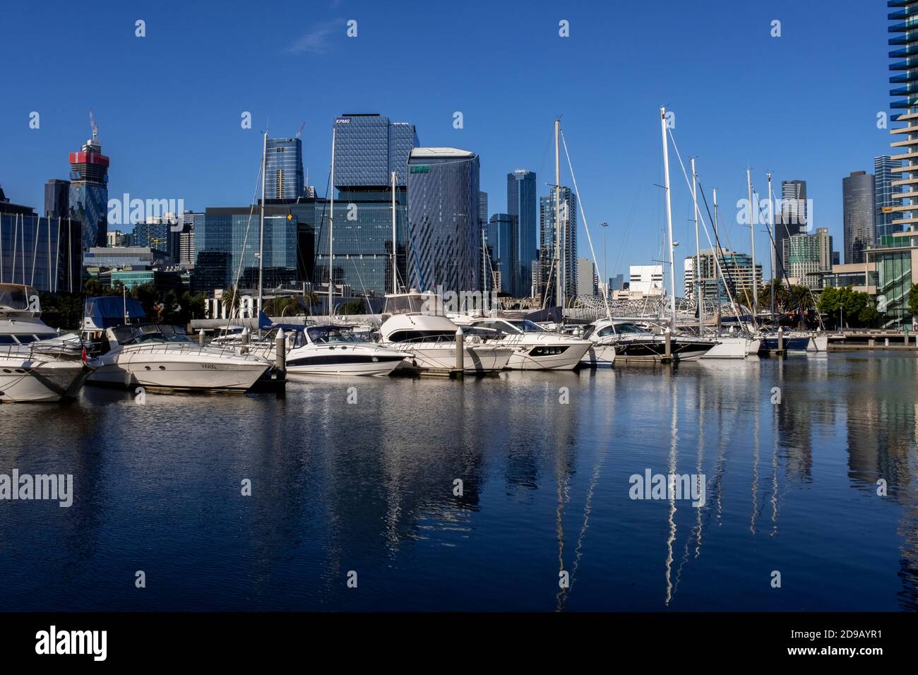 Boats moored at the Yarra's edge marina in front of the Melbourne skyline. Stock Photo