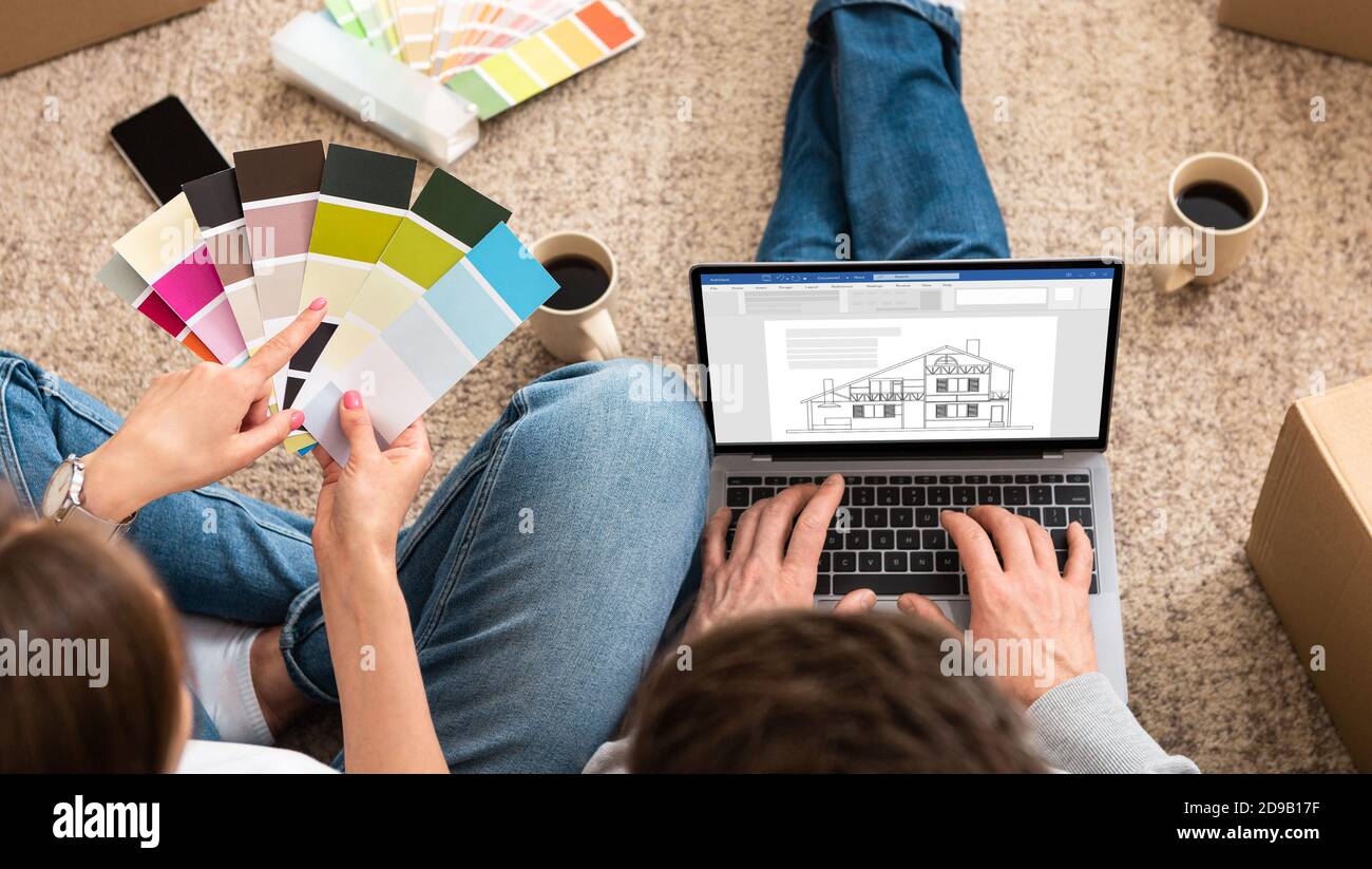 Couple moving to new house, planning interior design with laptop and ...