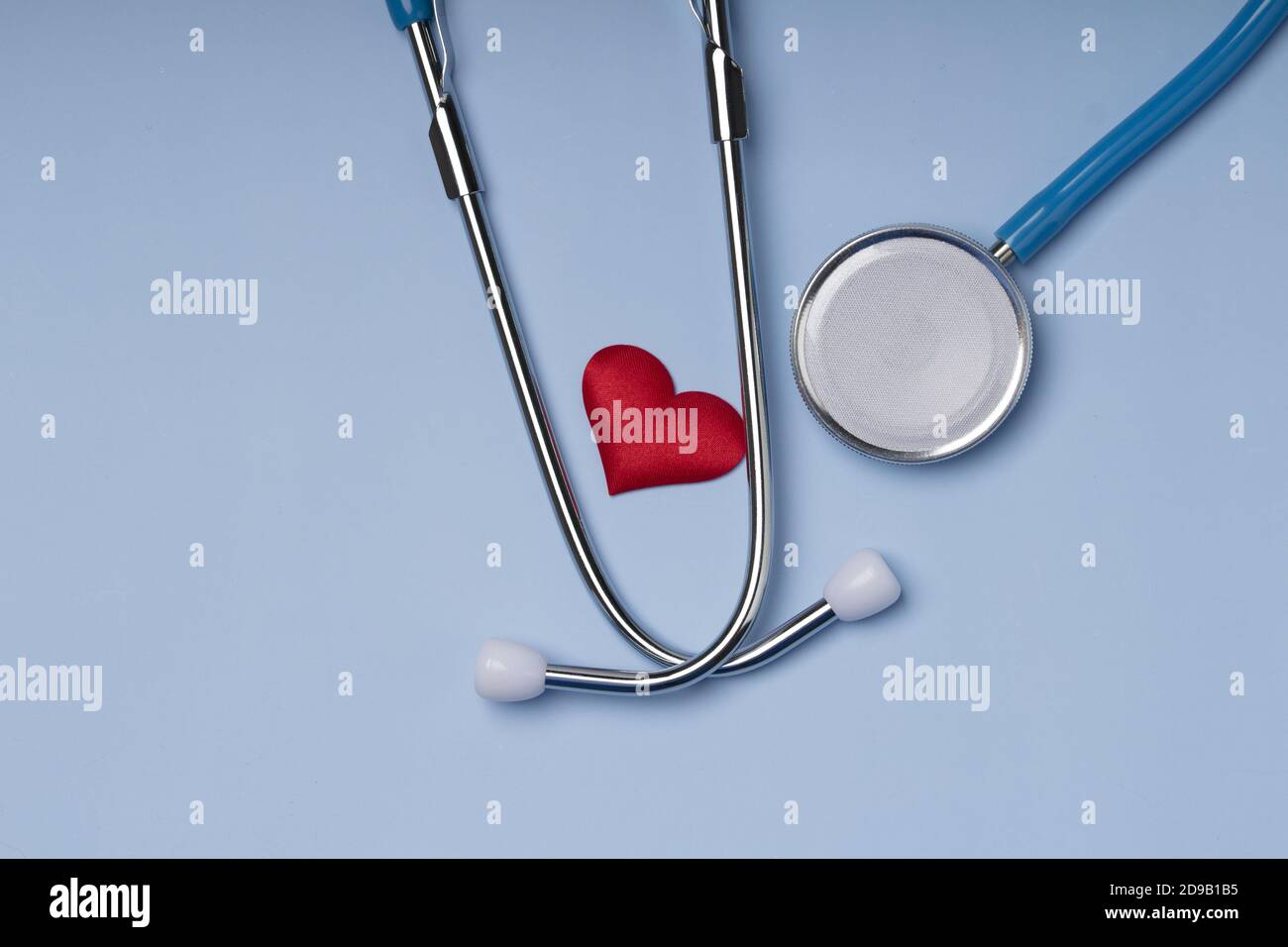 Stethoscope and red heart on blue background .Cardiology concept Stock ...