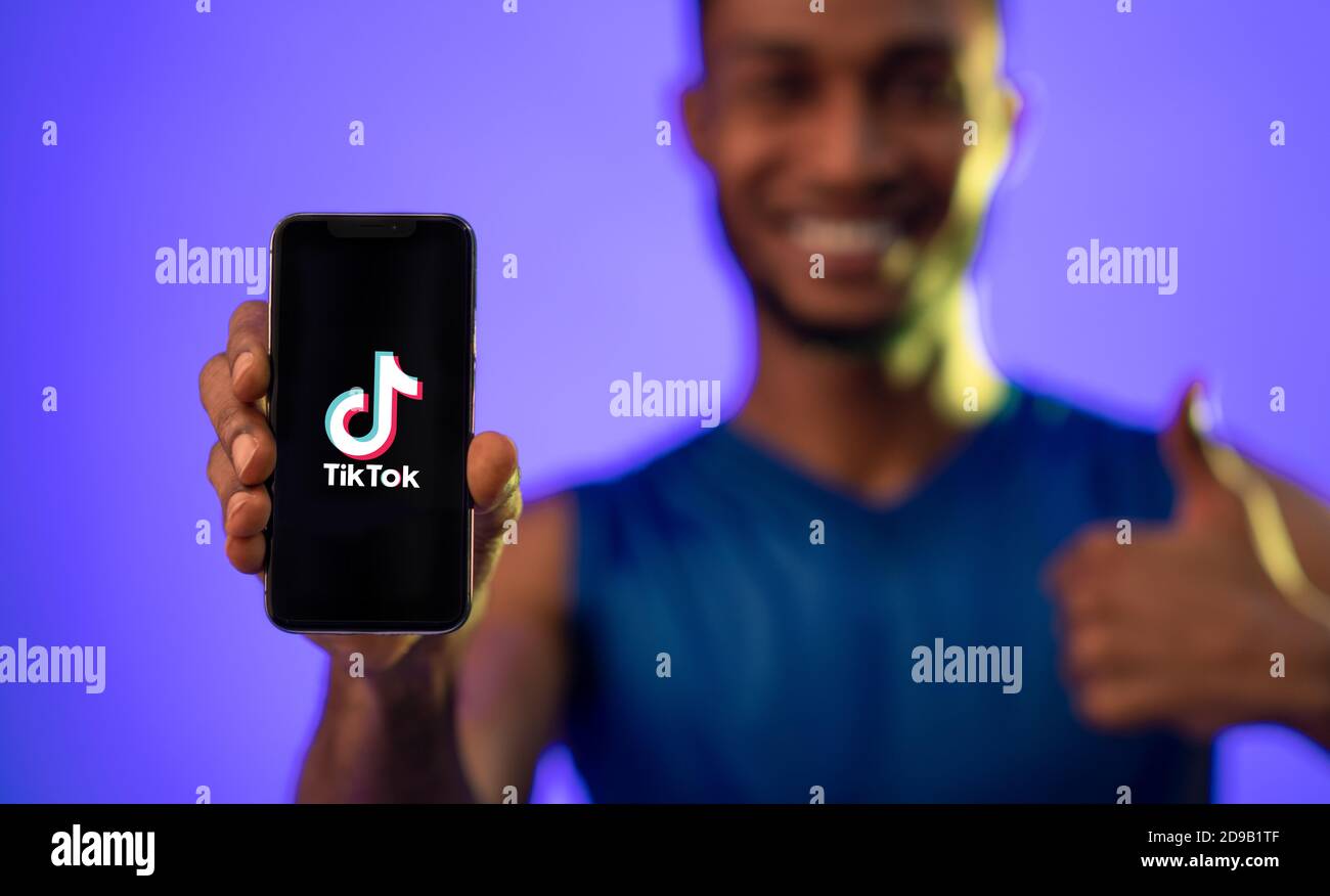 Black man holding smart phone with Tik Tok app Stock Photo Alamy