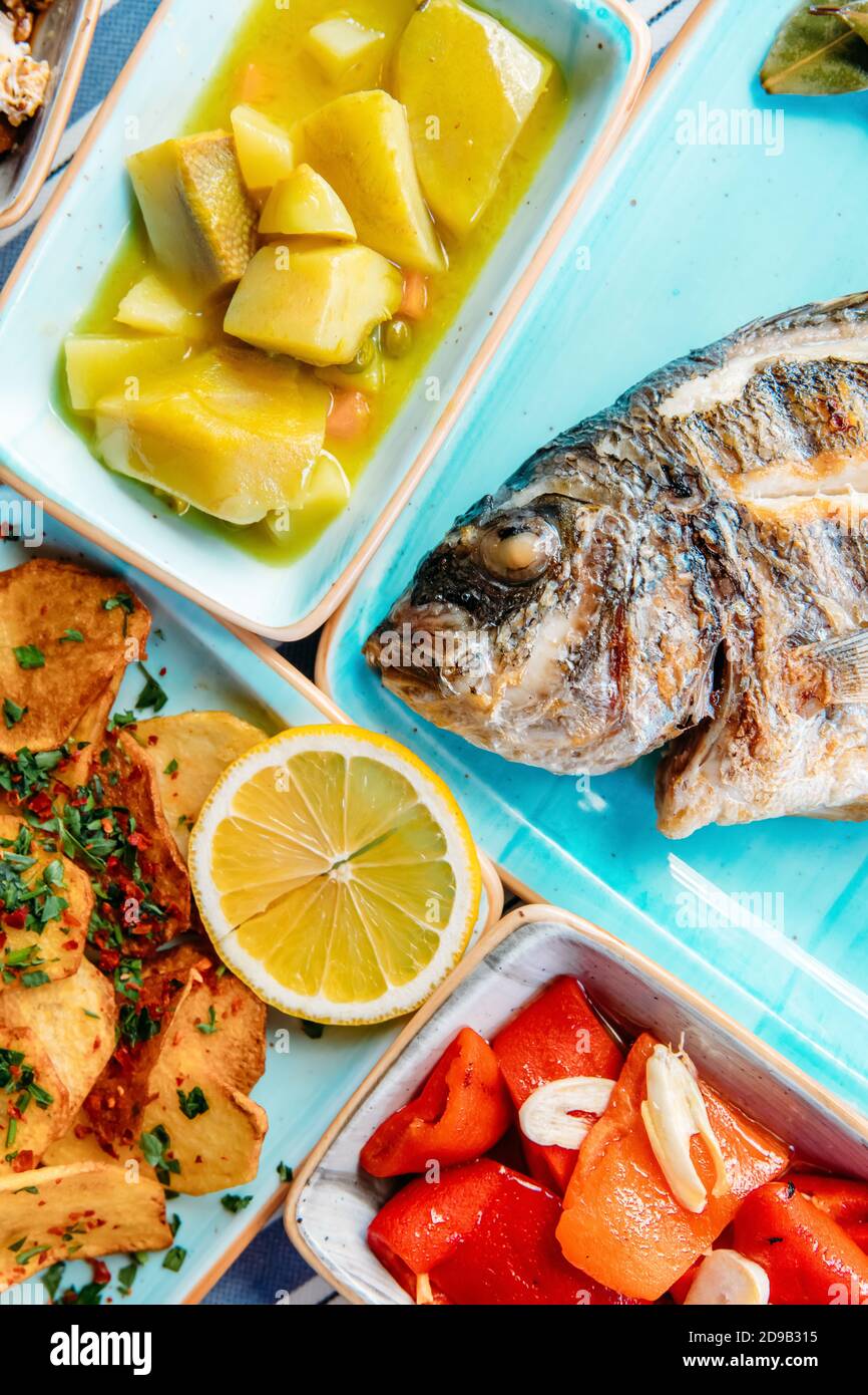 Seafoods, grilled meat, meze, herbs, fish, raki, ouzo, appetizers and salads in Greek or Turkish
