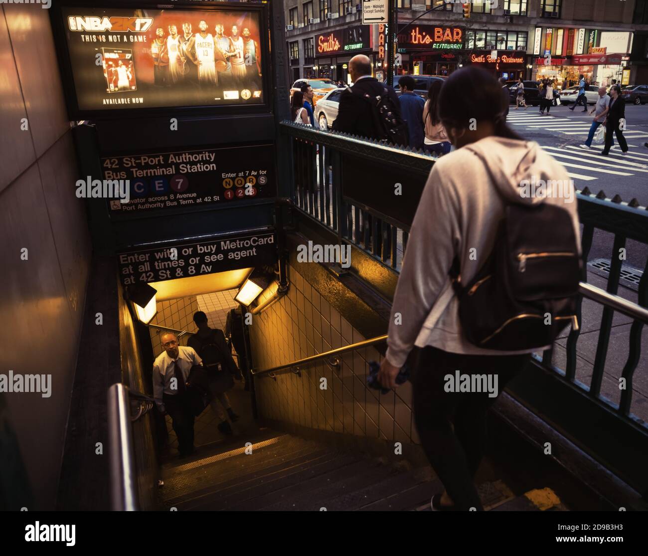 NEW YORK, USA - Sep 20, 2016: Blurred people walking in front of NYC subway entrance in evening time. NYC Subway is one of the oldest and most extensi Stock Photo