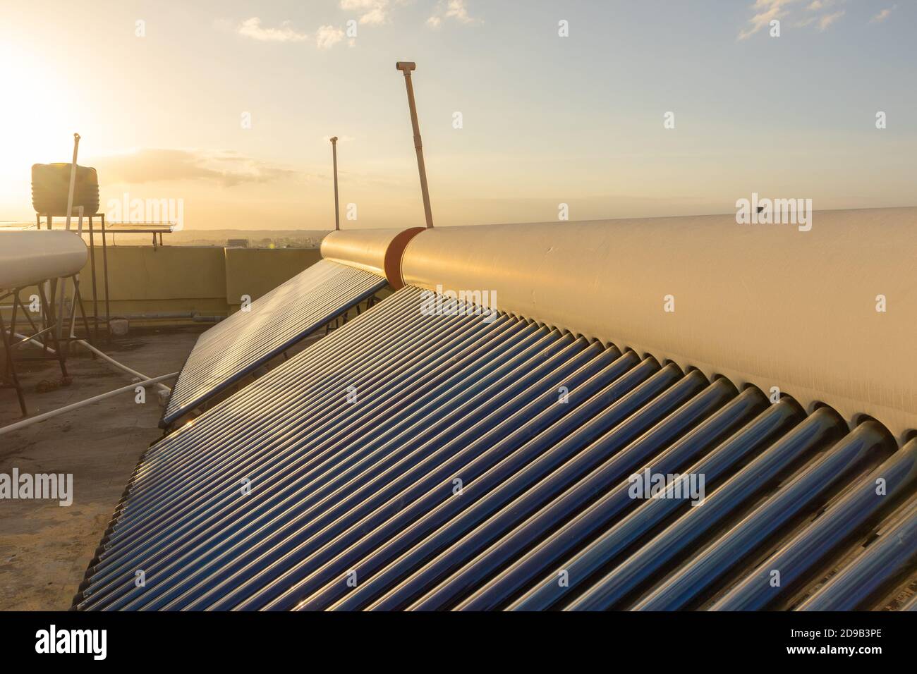 solar panels and tubes installed on house roof tops and building tops  to conserve energy for water heating Stock Photo