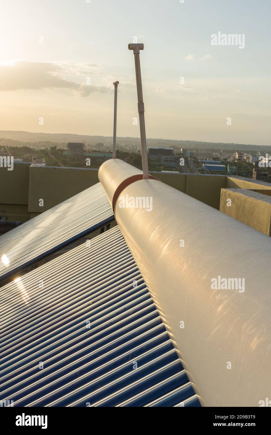 solar panels and tubes installed on house roof tops and building tops  to conserve energy for water heating Stock Photo