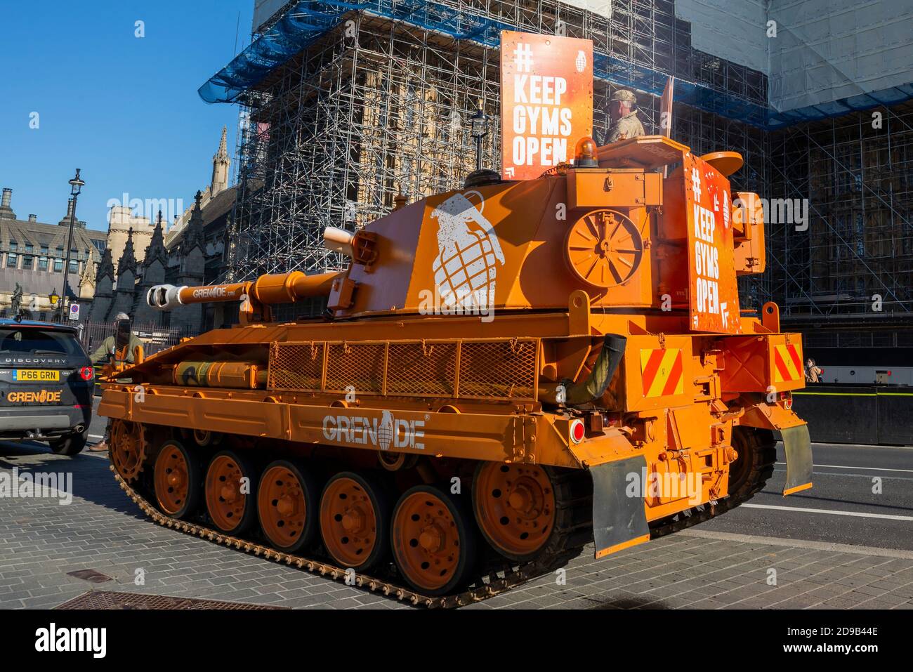 Westminster, London, UK. 4th Nov, 2020. An ex British Army Abbott tank (more correctly a self propelled gun) has been driving around Westminster and Parliament in protest at the closure of gyms during the COVID-19 Coronavirus lockdown. The orange de-mobbed Vickers Abbot FV433 armoured vehicle is advertising Grenade, a nutrition bar. Outside Parliament Stock Photo