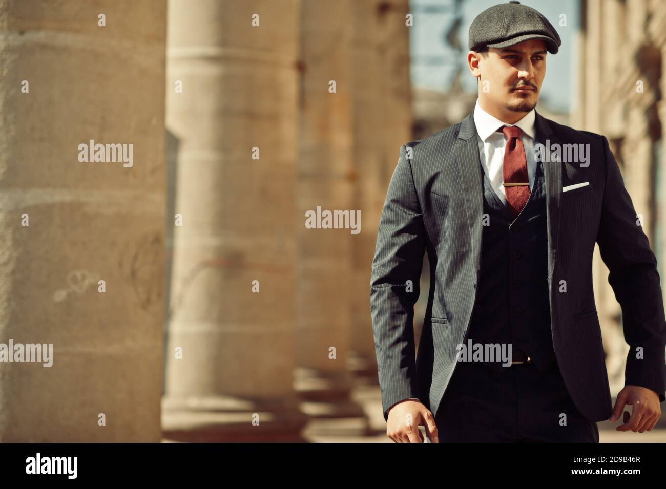 Portrait of retro 1920s english arabian business man wearing dark suit