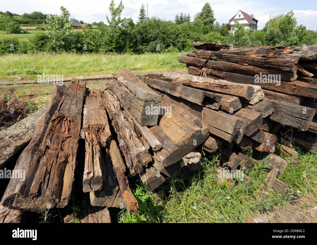 Dobra. Poland. The pile of worn old railwaily sleepers stacked near the railway track. Stock Photo