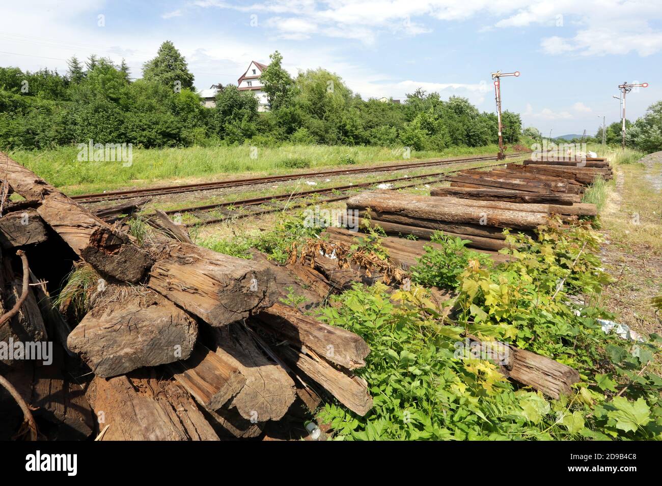 Dobra. Poland. The pile of worn old railwaily sleepers stacked near the railway track. Stock Photo
