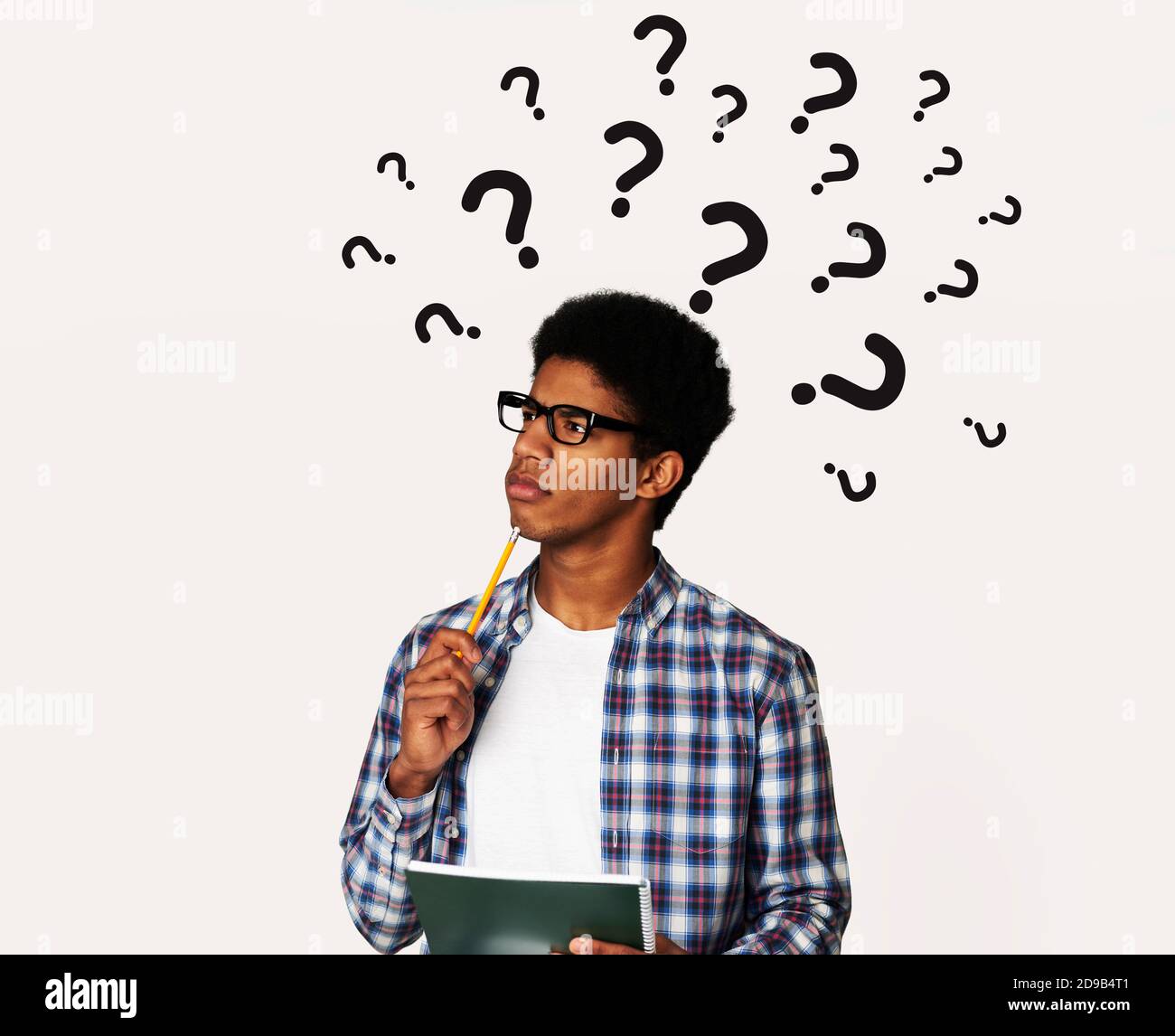 Pensive black man with question marks over his head deep in thought