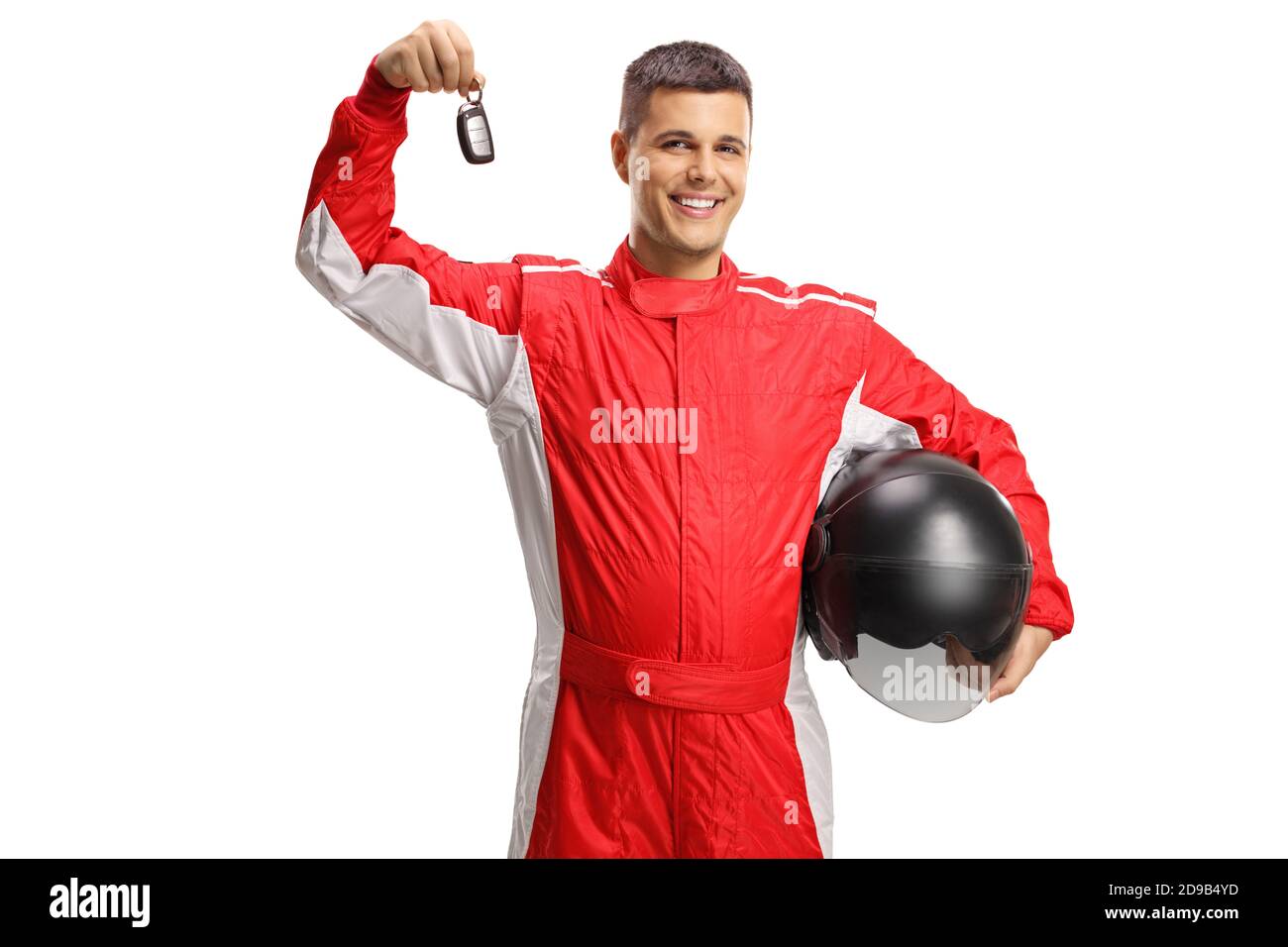 Male racer standing and holding a helmet and a car key isolated on ...