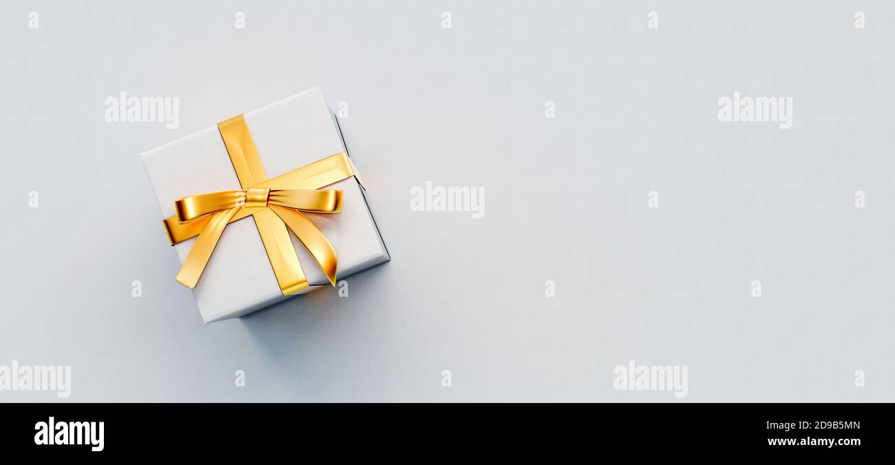 White gift box with golden bow on white paper background 3D Rendering Stock Photo